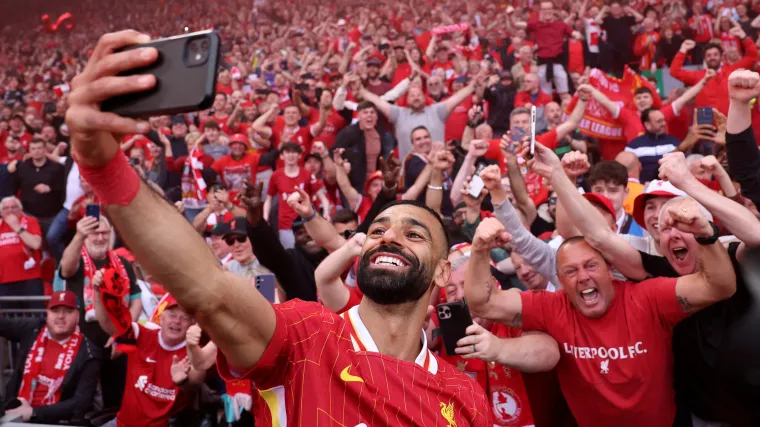 Mohamed Salah celebrates by taking a selfie after winning the Premier League.